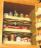 Three-tier D-shaped Lazy Susan with white polymer trays organizing canned goods in upper pantry cabinet